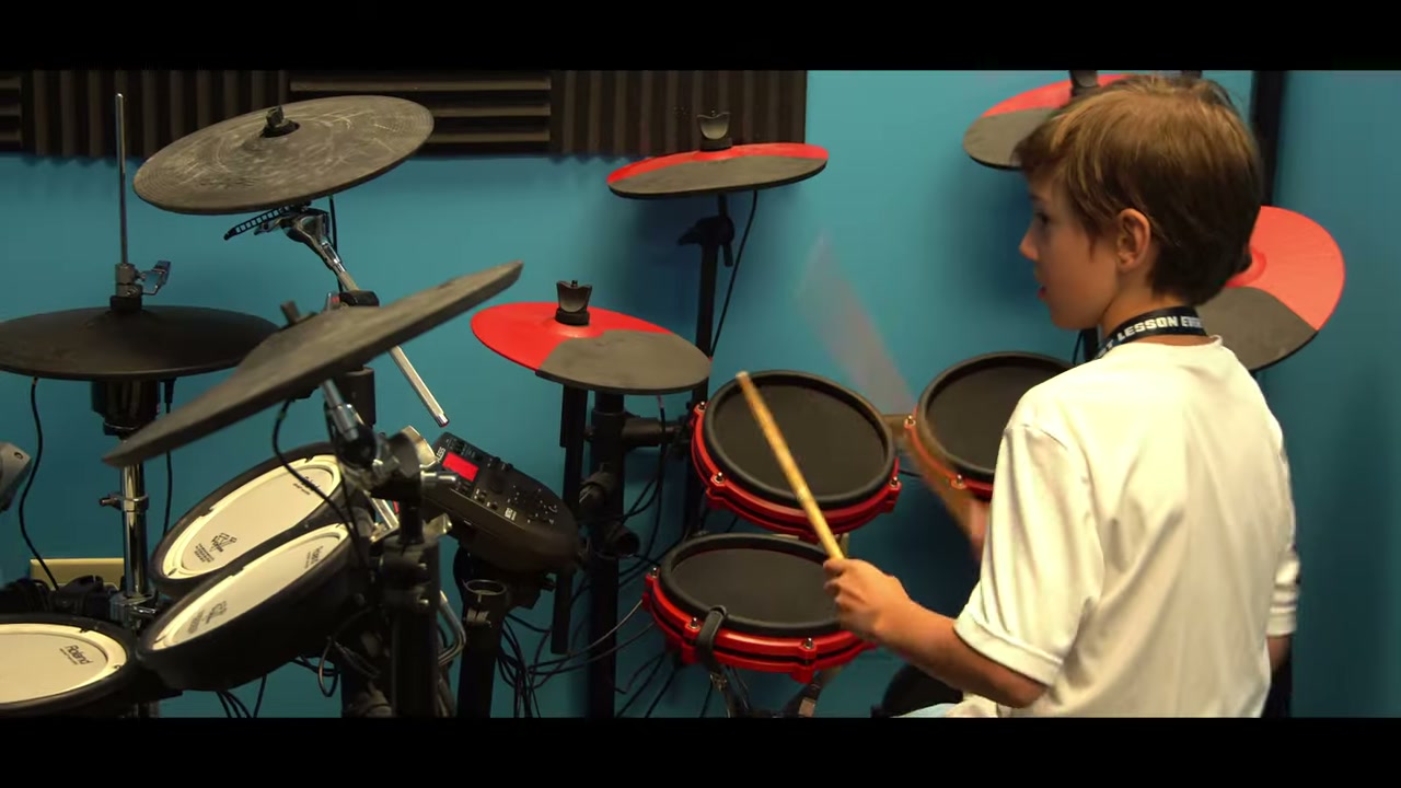 A BLE drum student playing an electronic drum kit in the studio