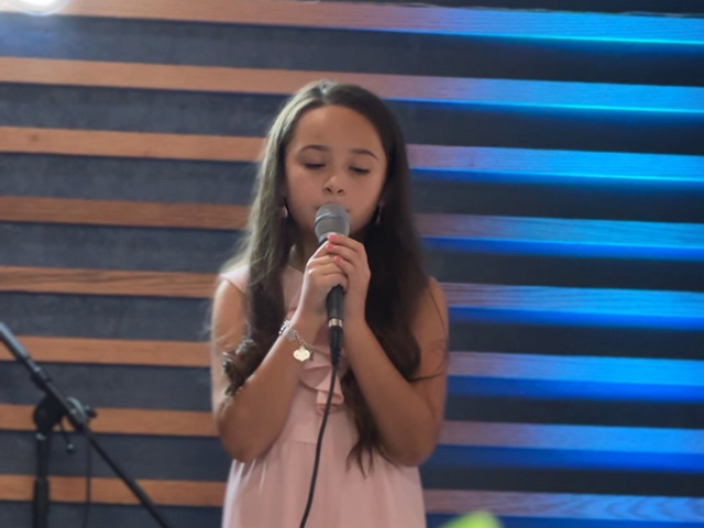 A BLE student performing on stage