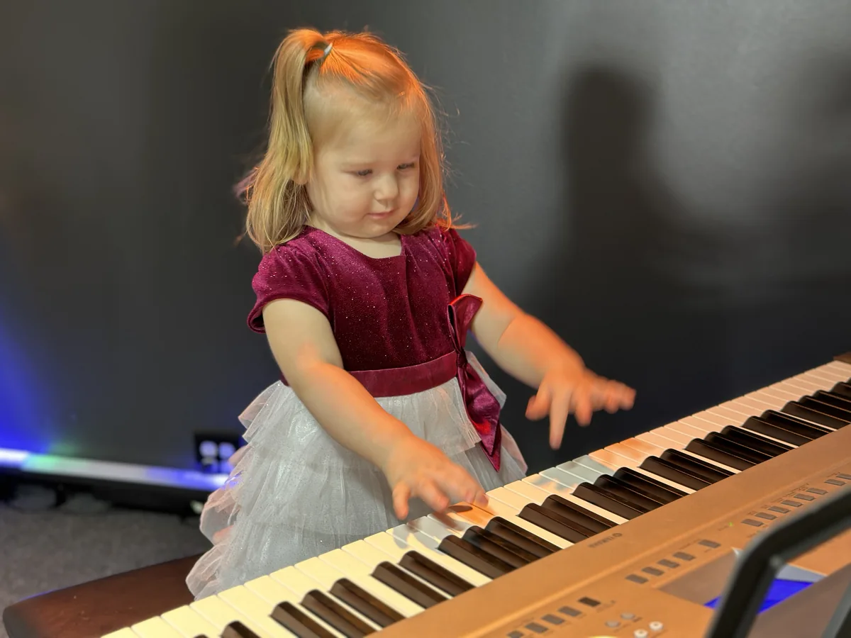 A young musician exploring the keys at BLE