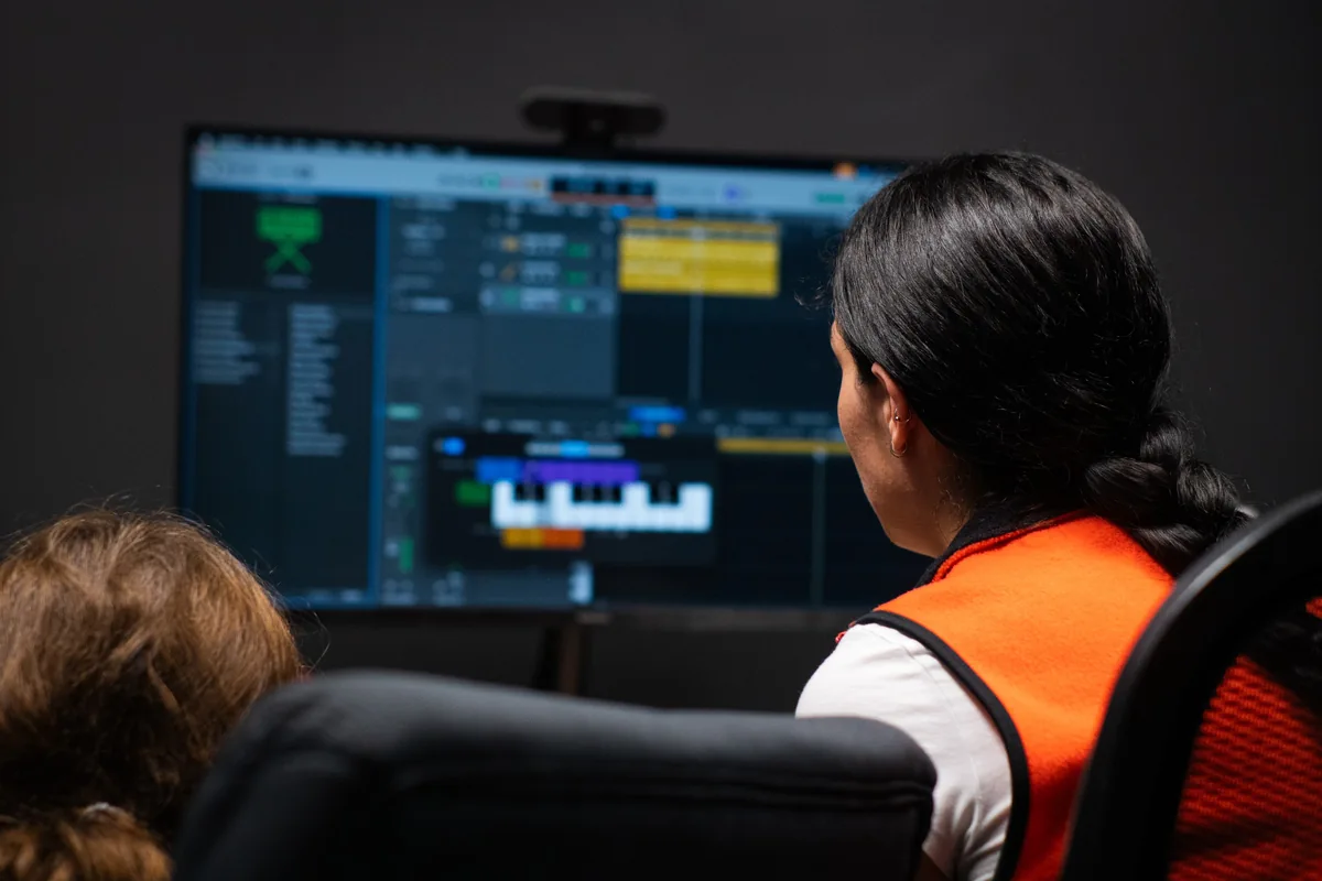 A BLE teacher and student using recording software in a lesson room