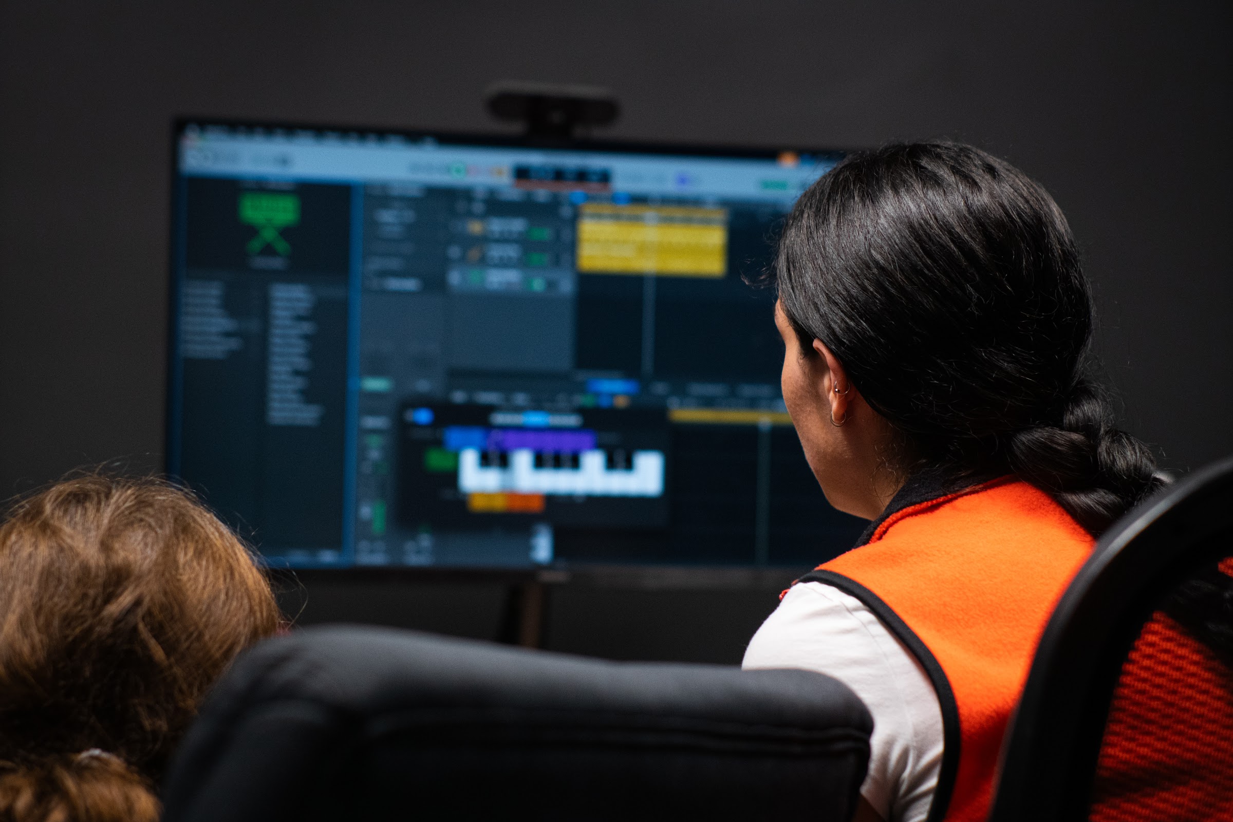A BLE teacher and student using recording software in a lesson-room recording studio